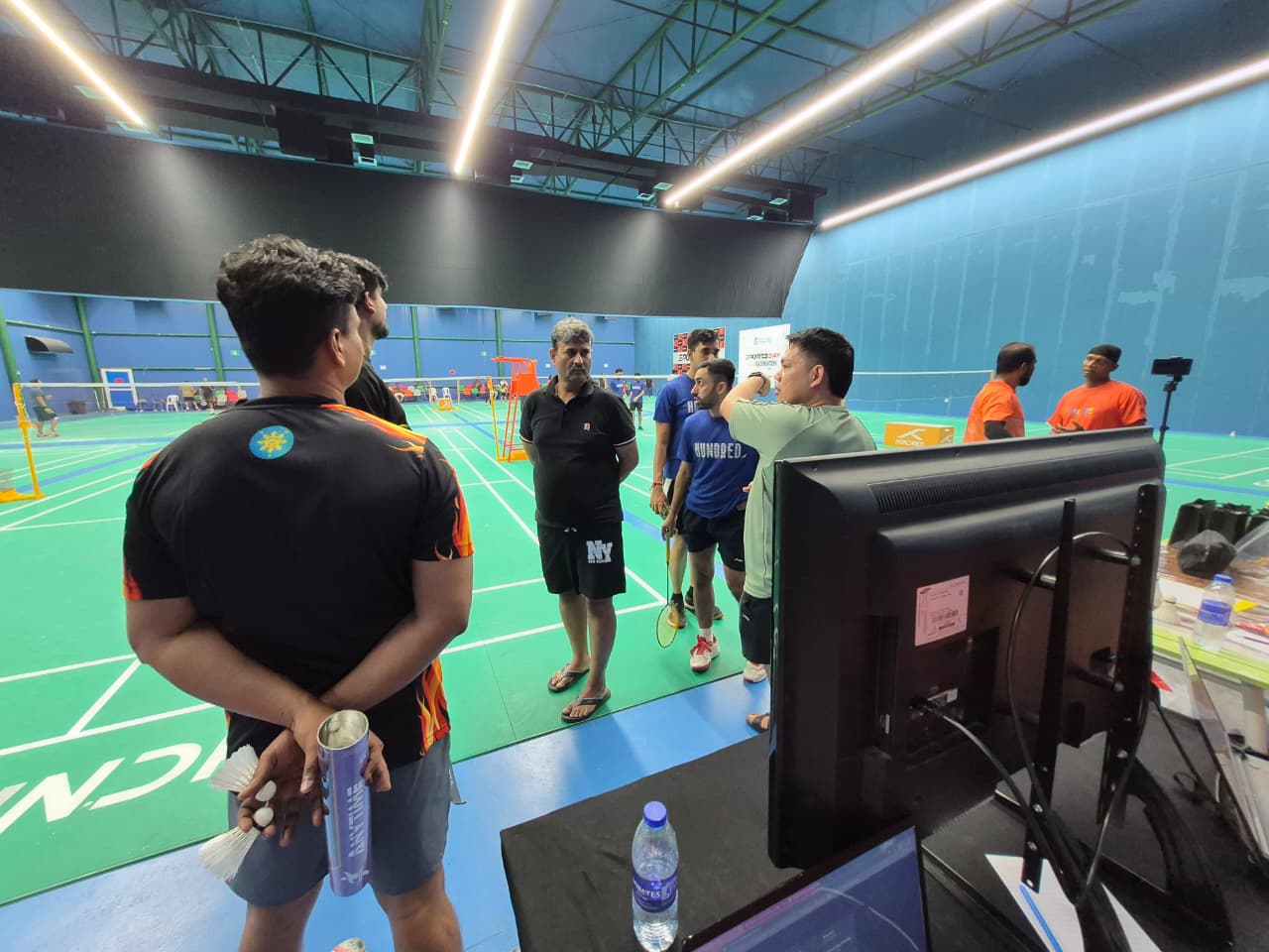 Players checking live tournament TV display at venue